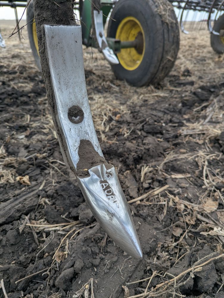 Close-up of a worn, dull shovel point on a field cultivator