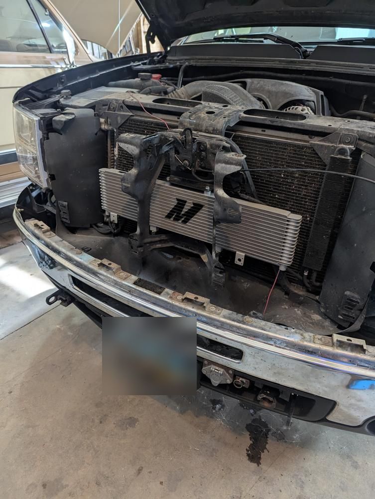 Front end of the 2013 GMC Sierra with the grille removed during a transmission cooler install